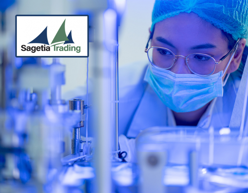 Front view portrait of man worker with protective mask and suit disinfecting industrial factory with spray gun.